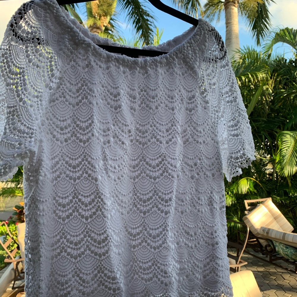 White lines lace off the shoulder top